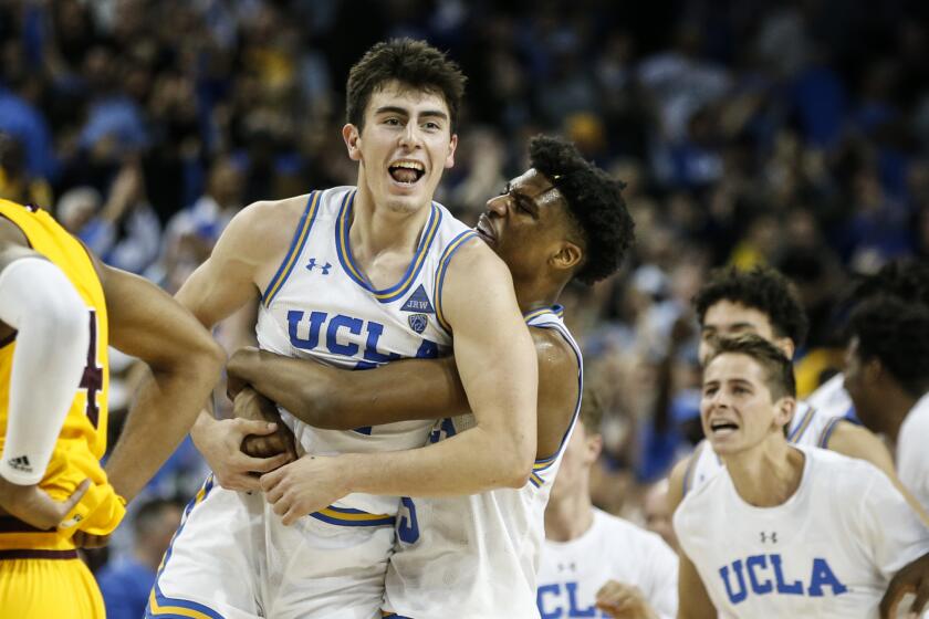 UCLA guard Jaime Jaquez Jr. (4) and UCLA forward Jalen Hill (24) celebrate after the team's win over Arizona State during an NCAA college basketball game Thursday, Feb. 27, 2020, in Los Angeles. (AP Photo/Ringo H.W. Chiu)