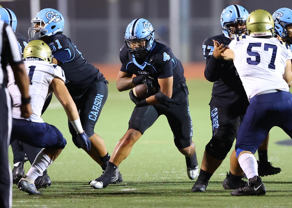 Jerry Misaalefua of Carson breaks through the line of scrimmage against Franklin's defense.