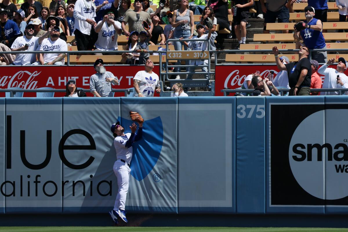 Dodgers outfielder James Outman is unable to catch a home run hit by the Nationals' CJ Abrams to lead off Wednesday's game.