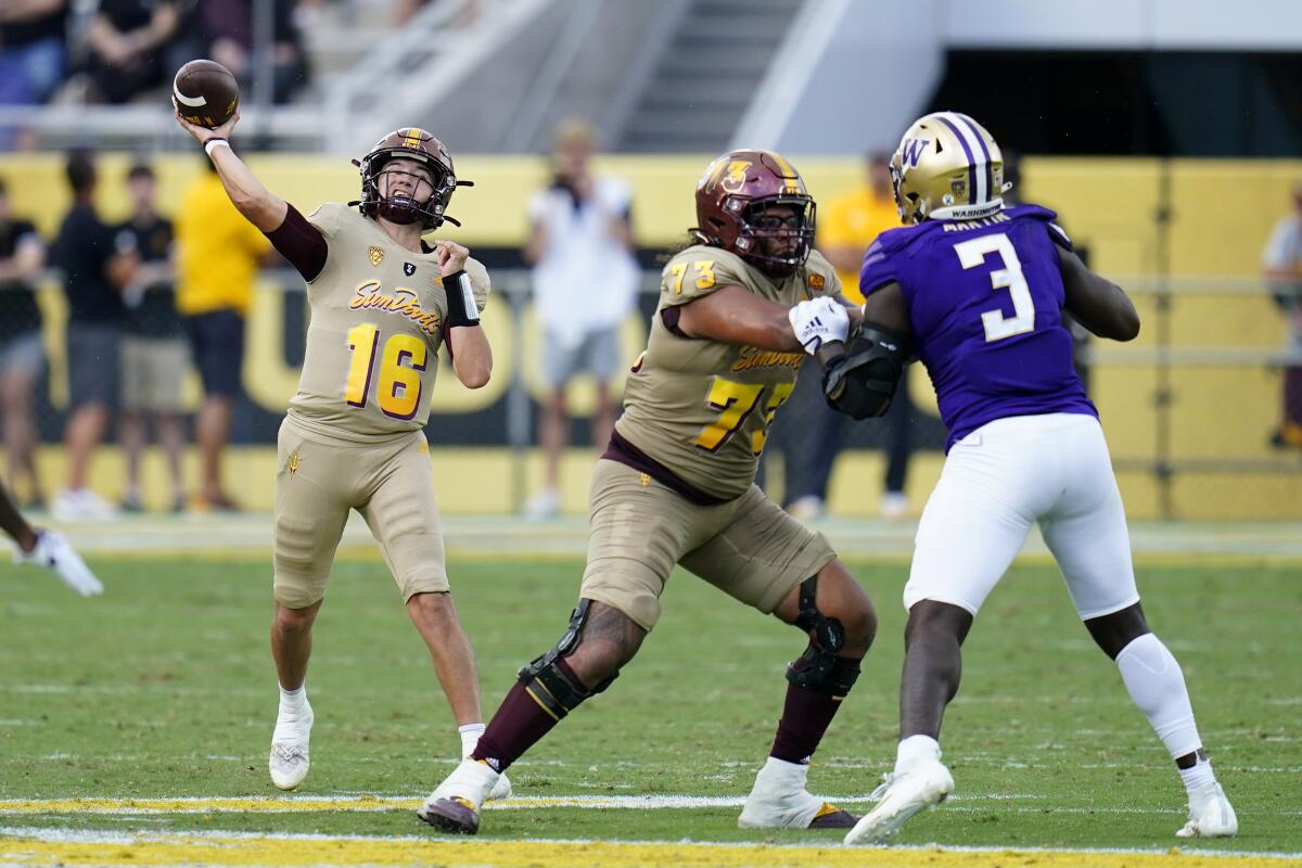 Arizona State quarterback Trenton Bourguet (16) throws a pass as offensive lineman Isaia Glass (73) blocks Washington defensive lineman Jeremiah Martin (3) during the second half of an NCAA college football game in Tempe, Ariz., Saturday, Oct. 8, 2022. (AP Photo/Ross D. Franklin)