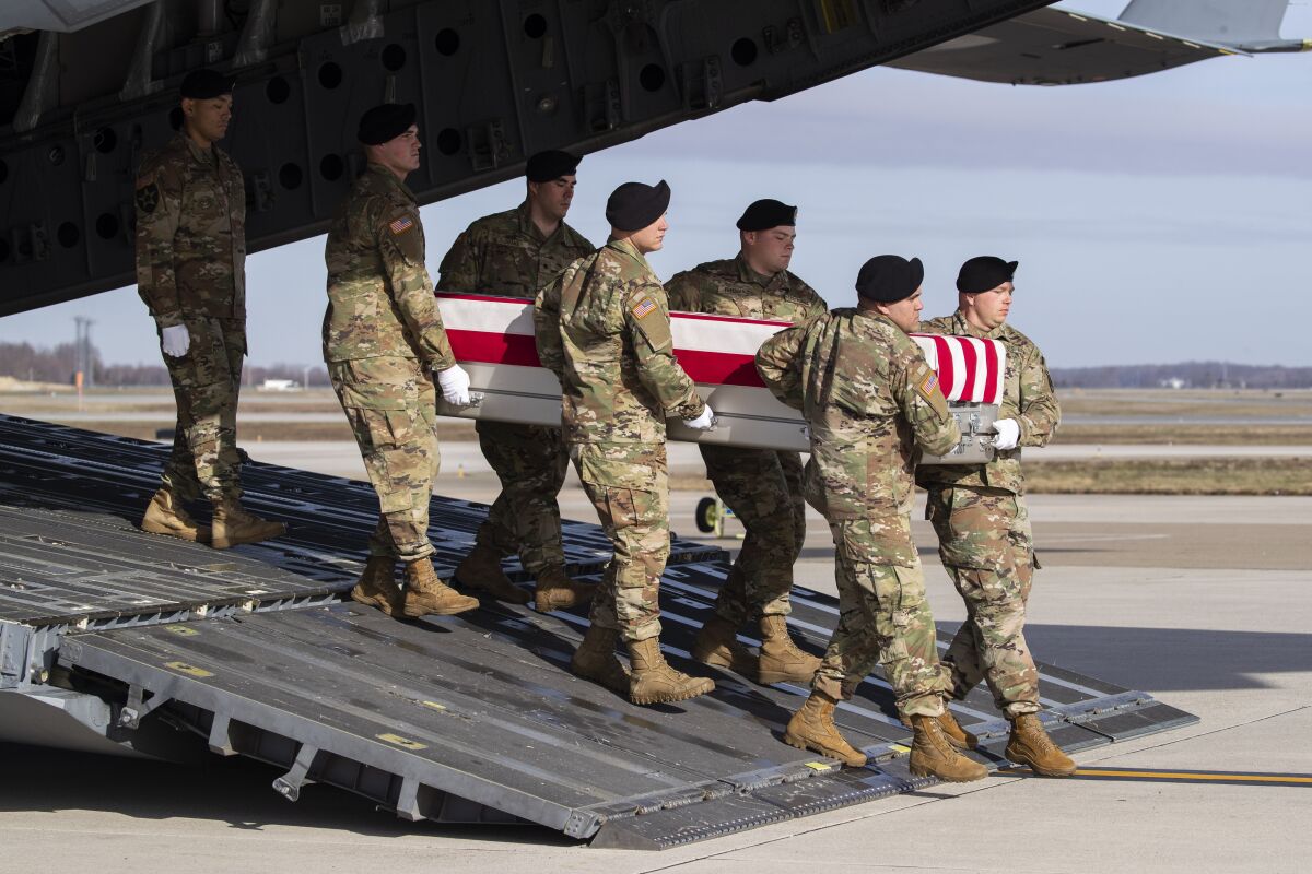 A U.S. Army team at Dover Air Force Base in Delaware carries the casket of a soldier killed recently in Afghanistan.