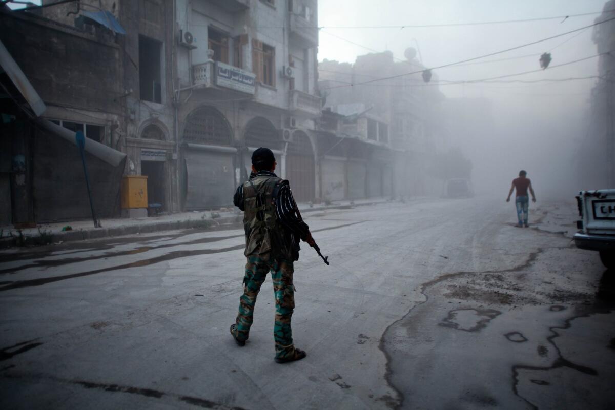A rebel fighter on a street in the old city of Aleppo, Syria, after an airstrike by Syrian government forces in July.
