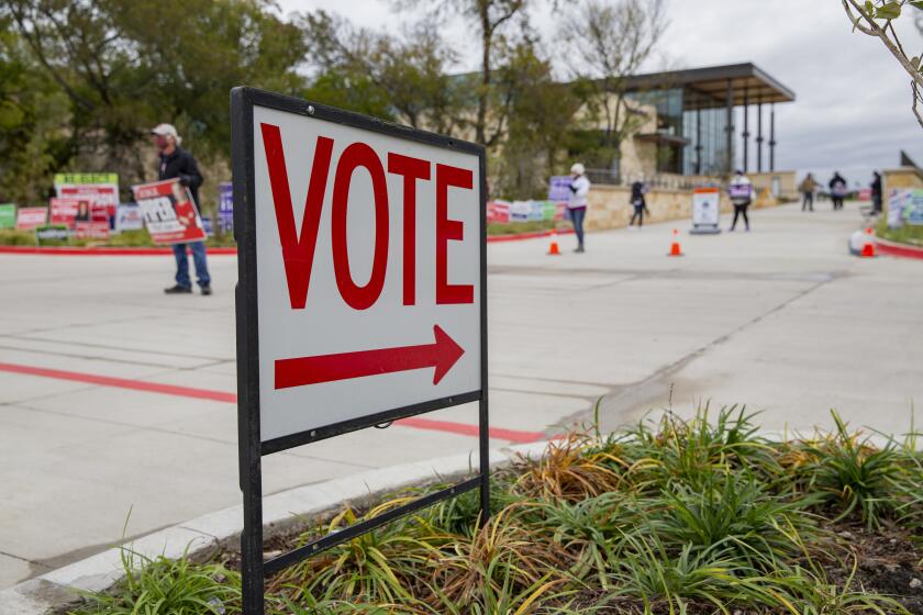 A sign directs people to an early voting poll at the Collin College campus in Wylie, Texas on Thursday, Oct. 29, 2020. (Juan Figueroa/The Dallas Morning News via AP)