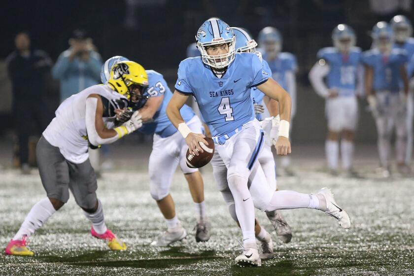 Corona del Mar quarterback Ethan Garbers runs out of trouble during the quarterfinals of the CIF Southern Section Division 3 playoffs against Cajon, on Saturday