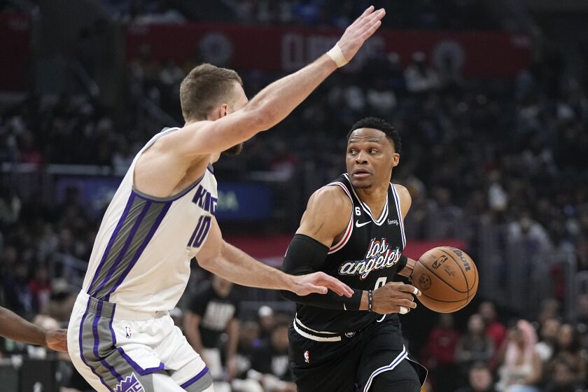 Los Angeles Clippers guard Russell Westbrook, right, drives by Sacramento Kings forward Domantas Sabonis during the first half of an NBA basketball game Friday, Feb. 24, 2023, in Los Angeles. (AP Photo/Mark J. Terrill)