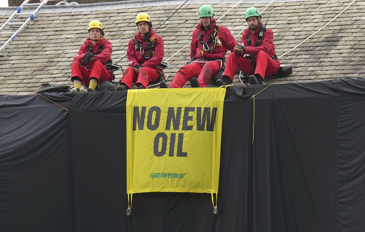 Greenpeace demonstrators protest U.K. prime ministers oil expansion
