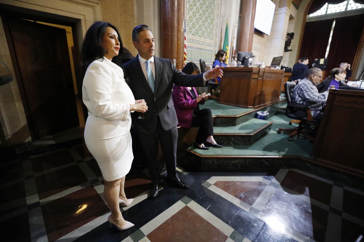 Los Angeles City Council 6th district representative Nury Martinez talks with Councilmember Joe Buscaino after she addressed the city council chambers.