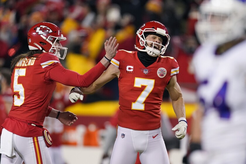 Kansas City Chiefs kicker Harrison Butker (7) celebrates with teammate Tommy Townsend (5) after kicking a 49-yard field goal during the second half of an NFL divisional round playoff football game against the Buffalo Bills, Sunday, Jan. 23, 2022, in Kansas City, Mo. (AP Photo/Charlie Riedel)