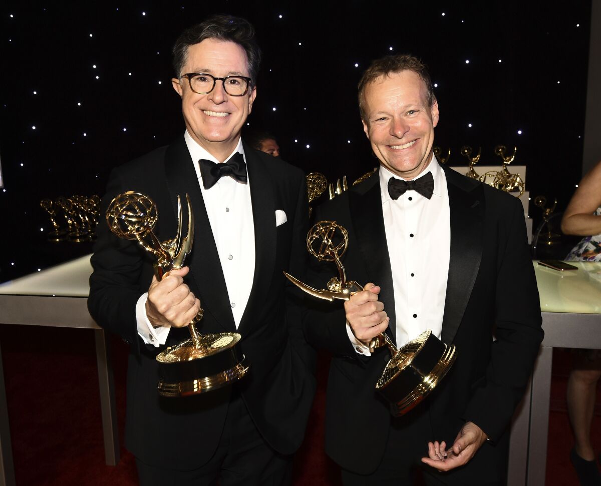 Stephen Colbert and Chris Licht hold Emmys