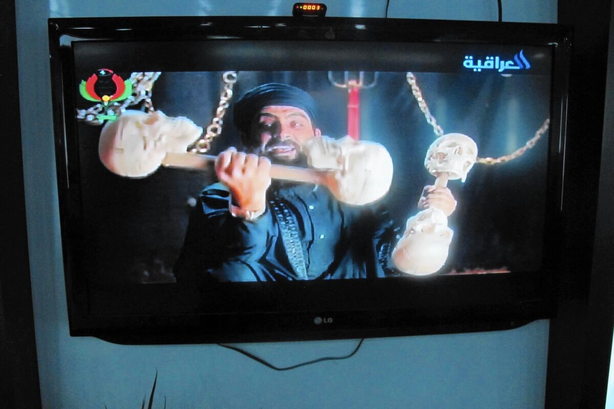 An Iraqi actor portrays a character spoofing Islamic State leader Abu Bakr Baghdadi, shown lifting barbells made of human skulls, in the hit TV show "State of Superstition."