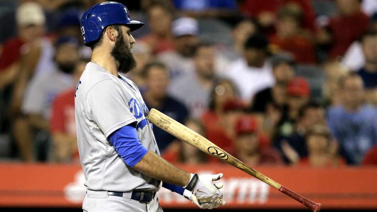 Dodgers first baseman Scott Van Slyke tosses his bat after striking out against Angels starter Garrett Richards in the fifth inning Wednesday night in Anaheim.