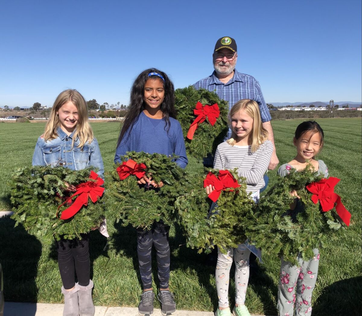Girl Scout Troop 3925 members with Vietnam veteran Wayne Buck at Miramar National Cemetery.
