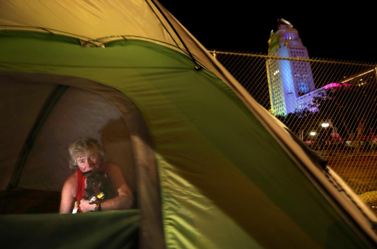 Tamela Kerneghan, 52, in her a new tent near Los Angeles City Hall, with her dog, Turbo.