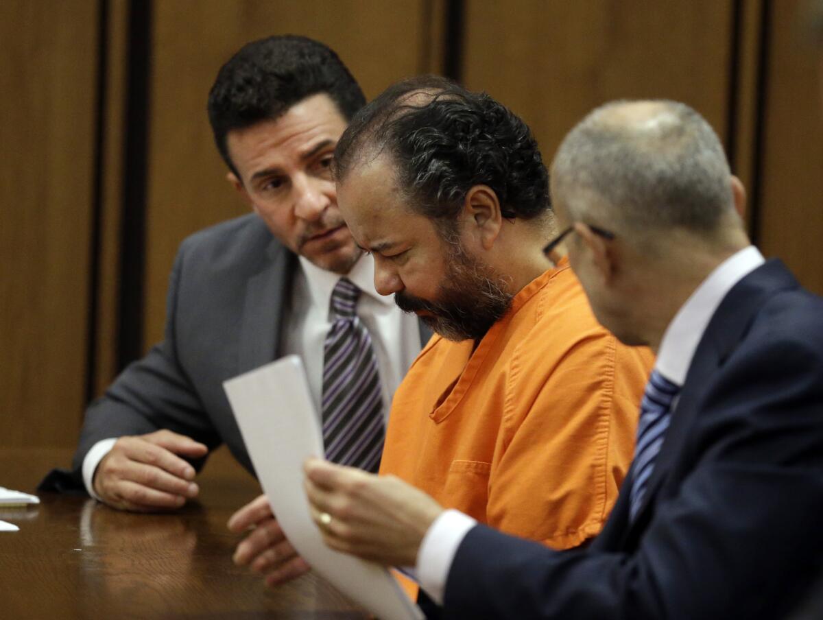 Ariel Castro, center, confers with his attorneys Craig Weintraub, left, and Jaye Schlachet during a pretrial hearing in Cuyahoga County Common Pleas Court in Cleveland.