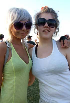 Alexandra Rohrscherb, left, and Kasha McCollough, both from New Mexico, soak up some desert sun at the Coachella music festival in Indio.