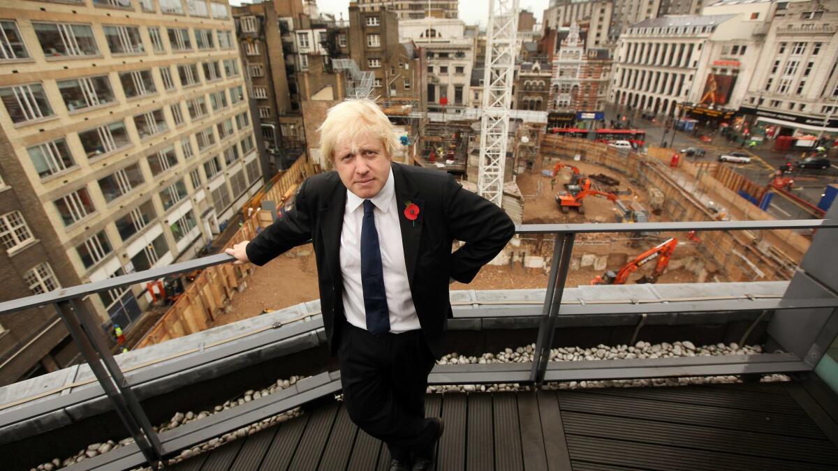 Then-London Mayor Boris Johnson stands on a balcony overlooking the Crossrail construction site at Tottenham Court Road subway station in 2009.