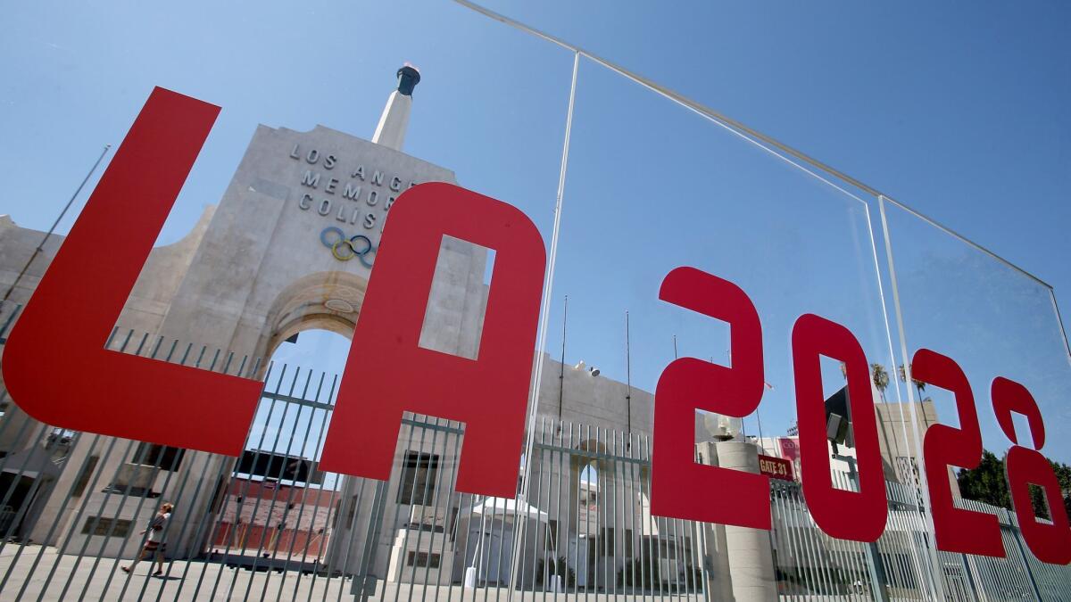 The Coliseum is framed by a plexiglass sign after Los Angeles was awarded the rights to host the 2028 Olympic Games on Sept. 13, 2017.