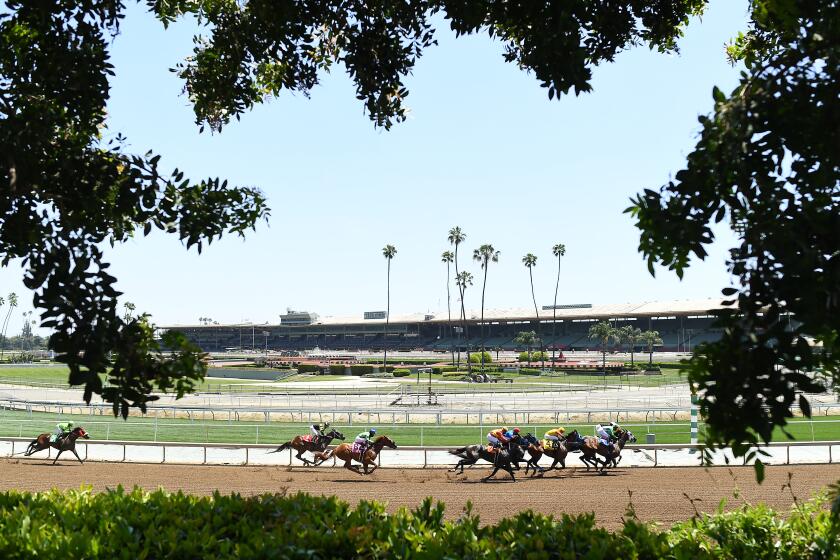 ARCADIA, CALIFORNIA MAY 23, 2020-Horses race around the turn at Santa Anita race track during the coronavirus pandemic. The coranavirus has limited employees at Santa Anita racetrack to essentail workers only. (Wally Skalij/Los Angeles Times)