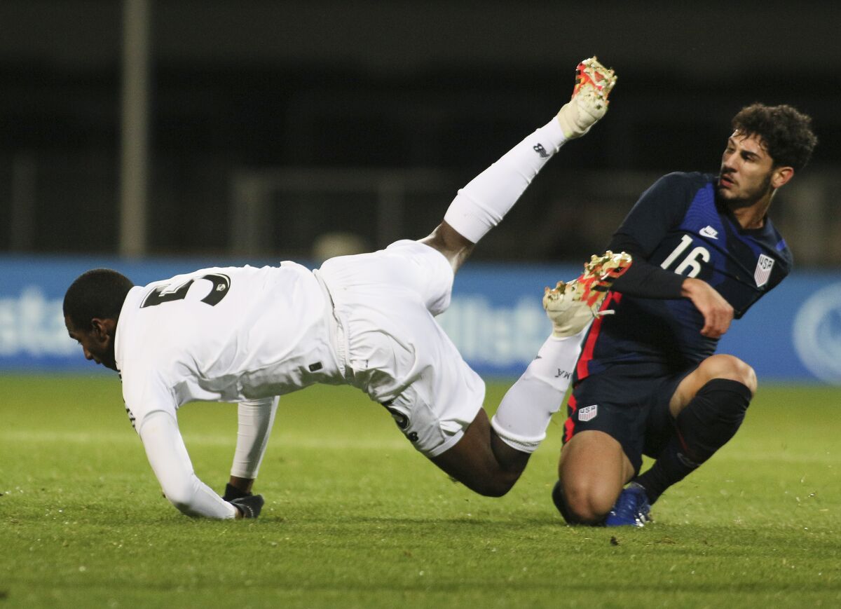 Panama's Abdiel Ayarza (5) falls as he is tackled by Johnny Cardoso of the U.S. during international friendly match Monday.