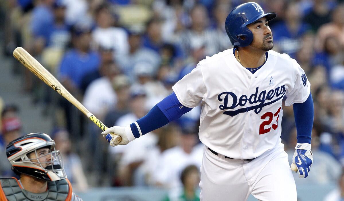 Los Angeles Dodgers’ Adrian Gonzalez hits a solo home run with San Francisco Giants catcher Andrew Susac looking on during a Dodgers' 10-2 rout over the Giants on Sunday.