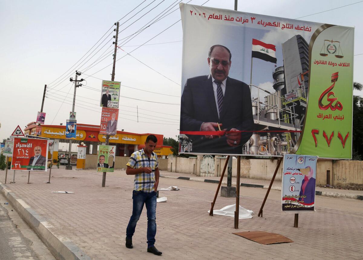 A campaign poster of Iraqi Prime Minister Nouri Maliki hangs in Basra, Iraq's second-largest city. If Maliki wins a third four-year term in parliamentary elections Wednesday, he is likely to rely on a narrow sectarian Shiite base.