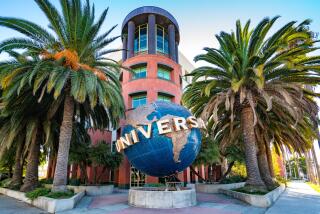 A globe fountain and palm trees decorate the entrance to the Universal Music Group office.