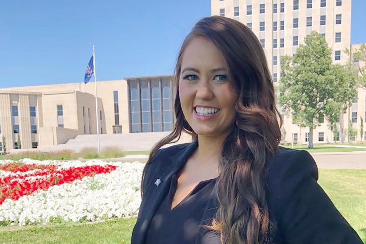 FILE - Cara Mund poses for a photo in front of the state Capitol in Bismarck, N.D. on Aug. 10, 2022. Mund's entry into North Dakota's U.S. House race has led Democrat Mark Haugen to drop out Sunday, Sept. 4, 2022, citing pressure from his own party to step aside. Mund entered the race in August as an independent, citing her support for abortion rights as a major reason. (AP Photo/James MacPherson, File)