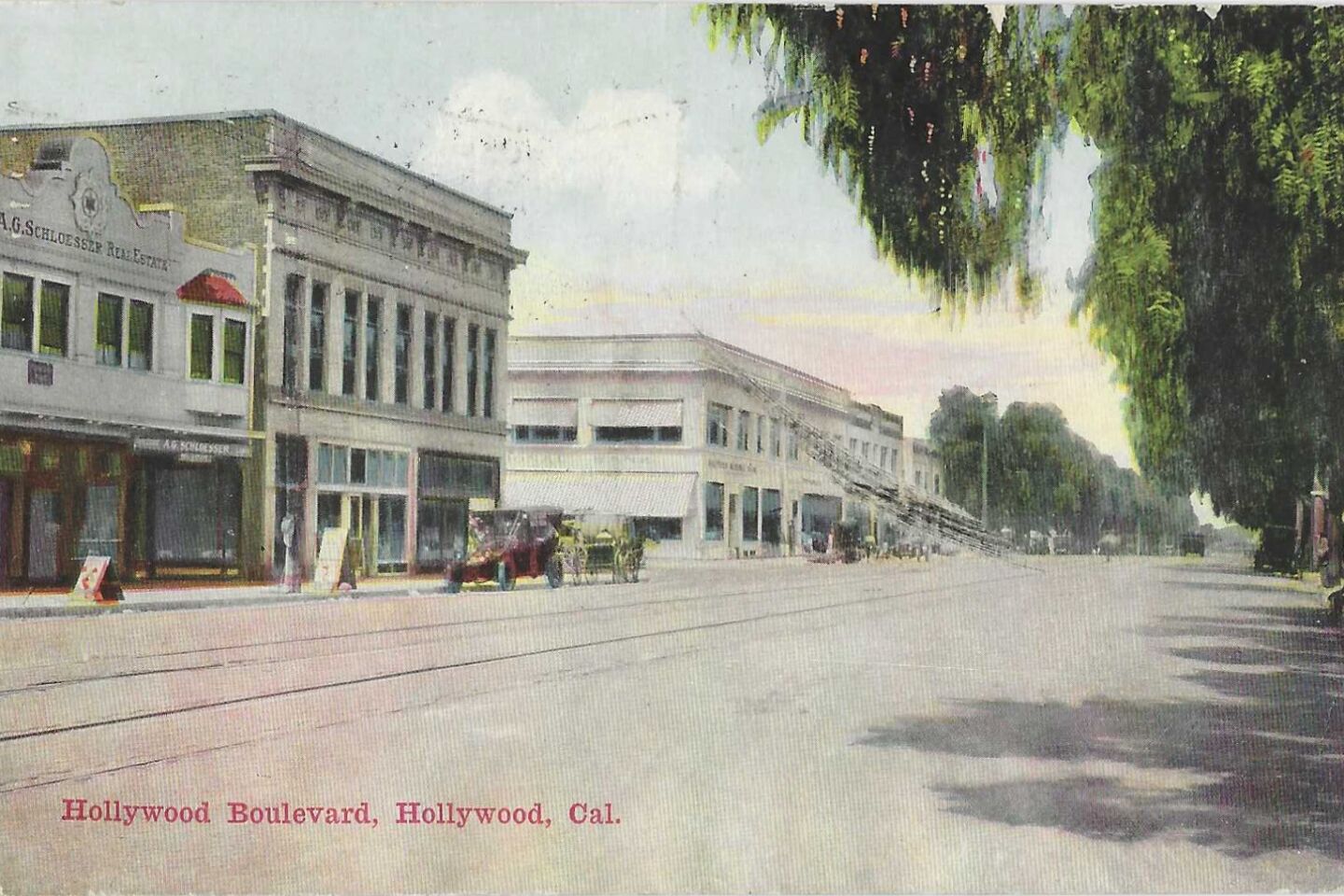 A vintage postcard shows a nearly empty Hollywood Boulevard
