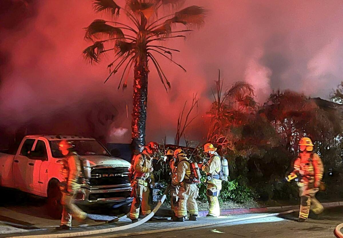 Costa Mesa and Newport Beach fire departments respond to an early morning house fire on Friday morning.