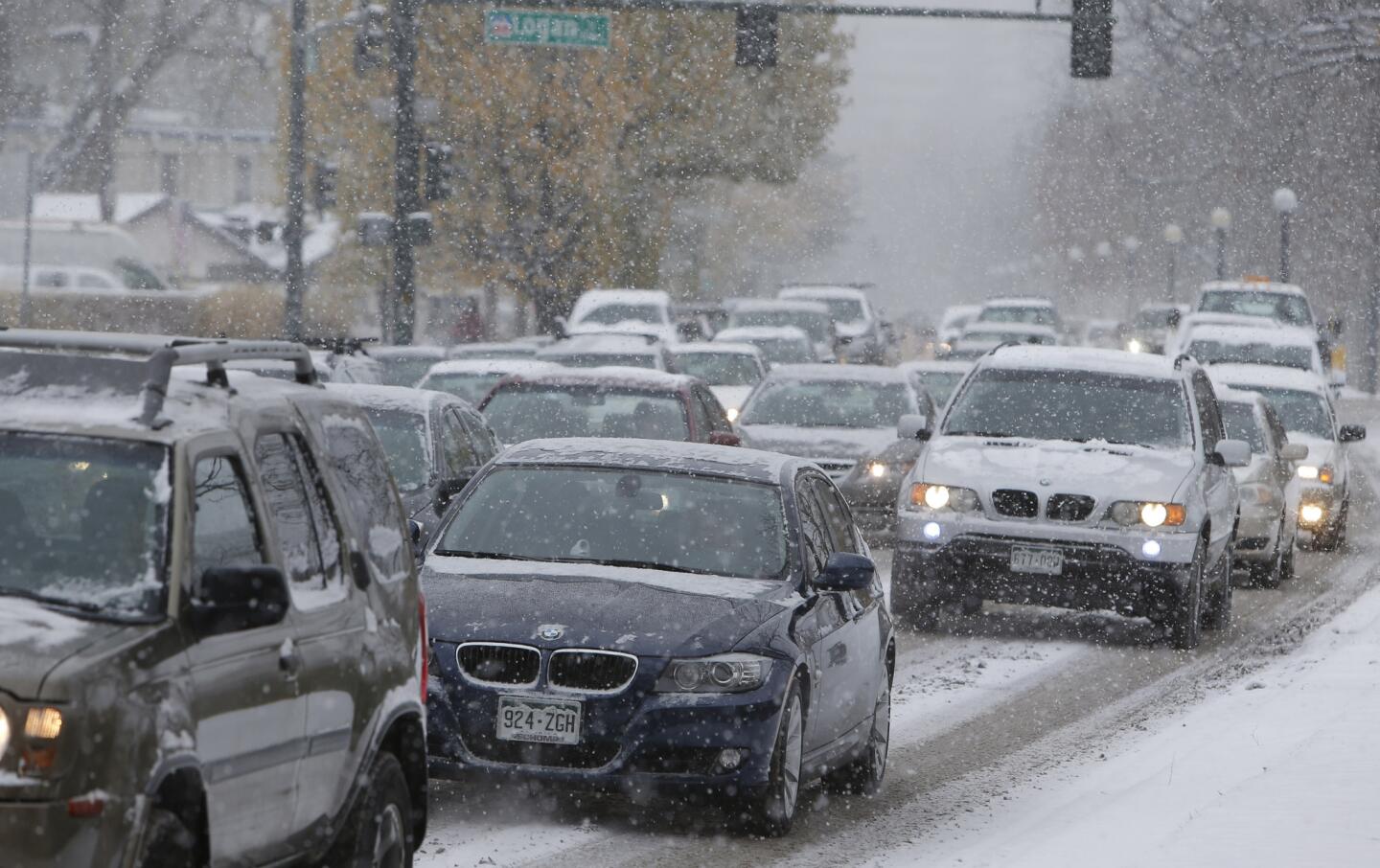 Motorists inch their way along Speer Boulevard in Denver as snow falls Wednesday.