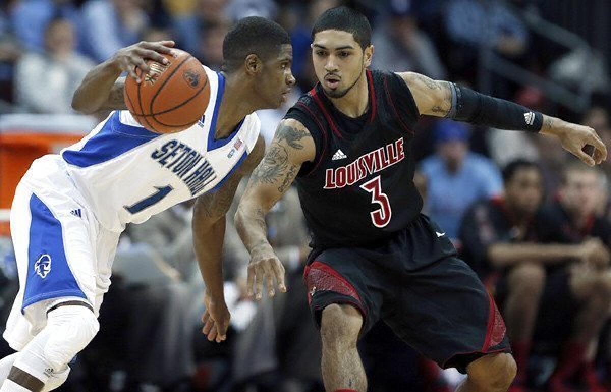 Louisville guard Peyton Siva (3) defends against Seton Hall guard Aaron Cosby (1) during a Big East Conference game Wednesday.