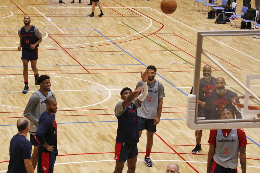 Washington Wizards players including Rui Hachimura, center, work out in Tokyo, Thursday, Sept. 29, 2022, ahead of the NBA preseason games in Japan. Japanese basketball fans will get to see NBA stars up close when the reigning league-champion Golden State Warriors take on the Washington Wizards in two preseason games. (AP Photo/Yuri Kageyama)