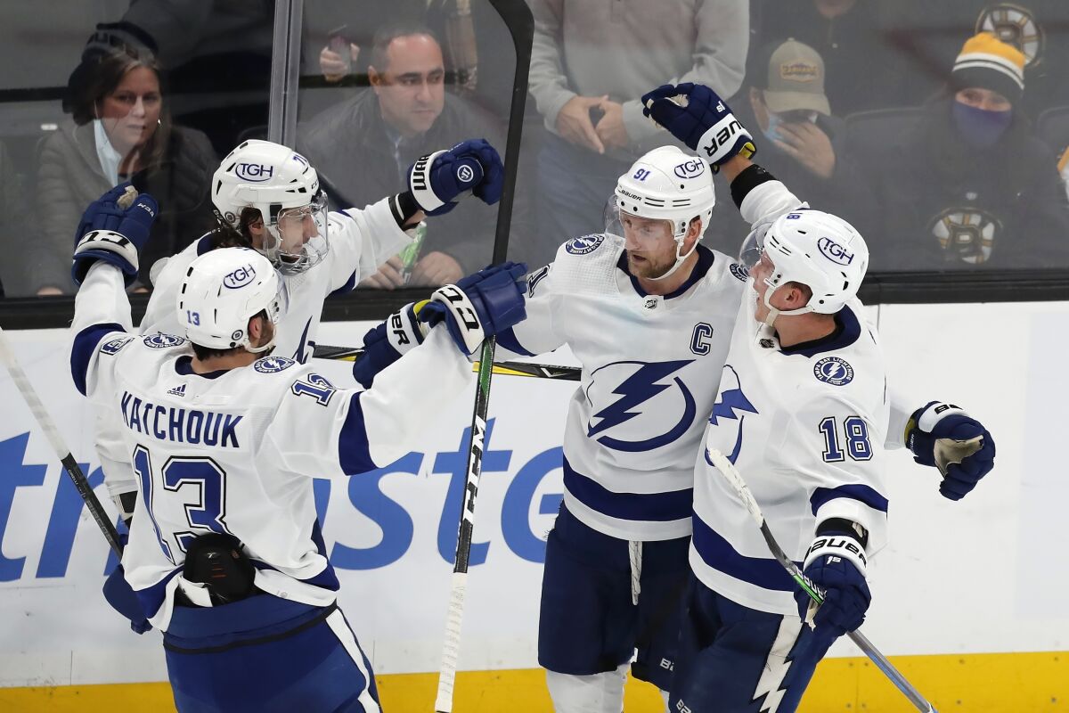 Tampa Bay Lightning's Steven Stamkos (91) celebrates with teammates after scoring in overtime during an NHL hockey game against the Boston Bruins, Saturday, Dec. 4, 2021, in Boston. (AP Photo/Michael Dwyer)