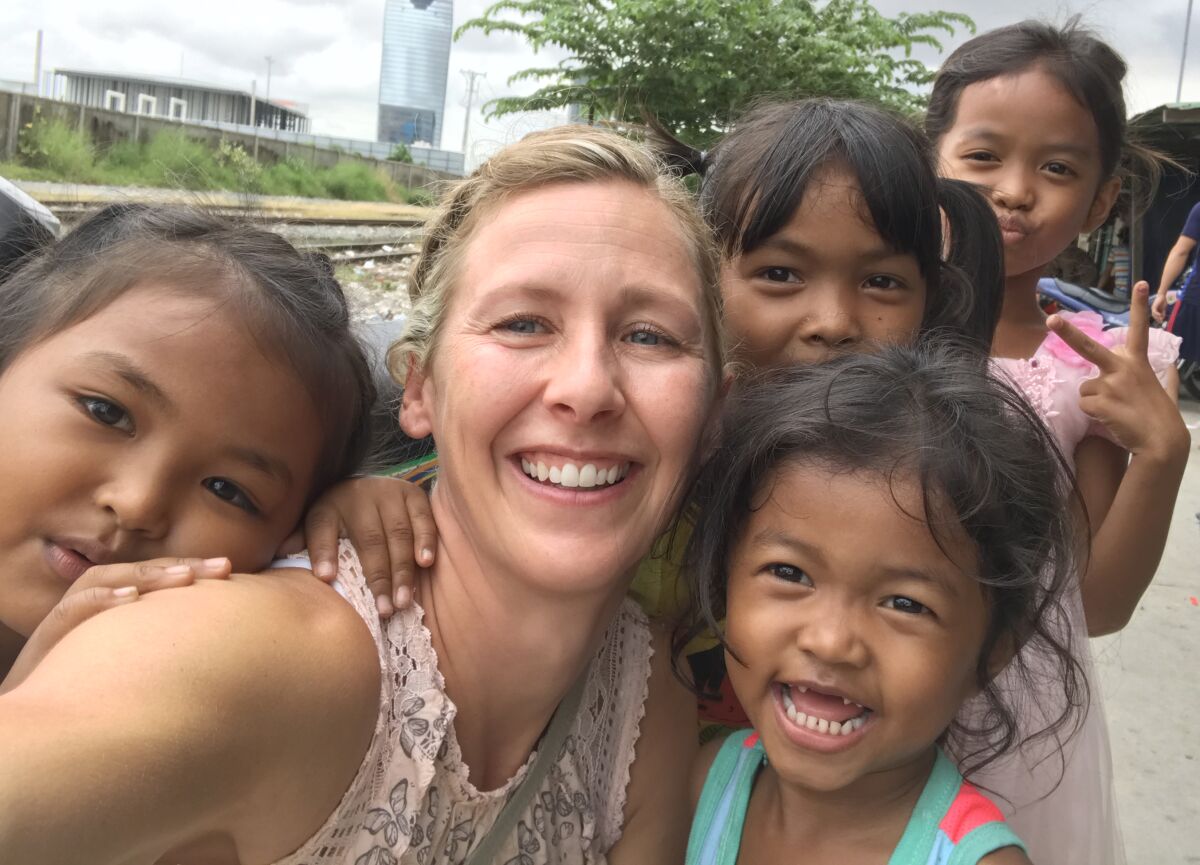 Brenda Herr, center, helps provide aid and support to children in Cambodia.
