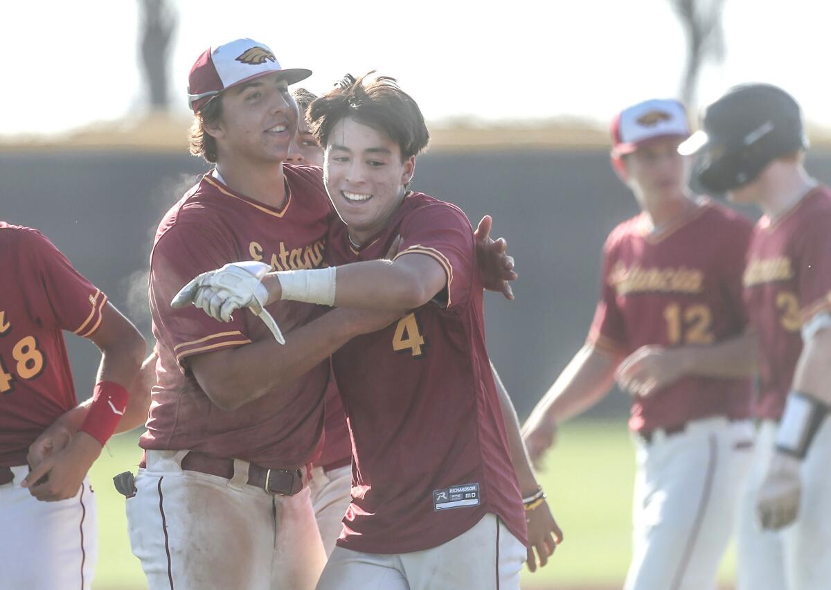 Estancia's Jake Humphries (4) celebrates with teammates after hitting a walk-off single against Pacifica Christian on Friday.