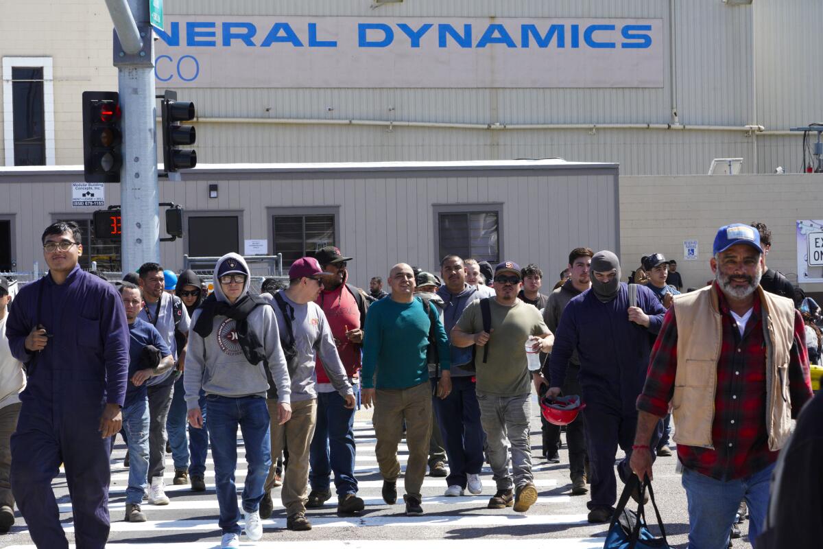 At General Dynamics NASSCO workers exit from the shipyard at the end of their work day.