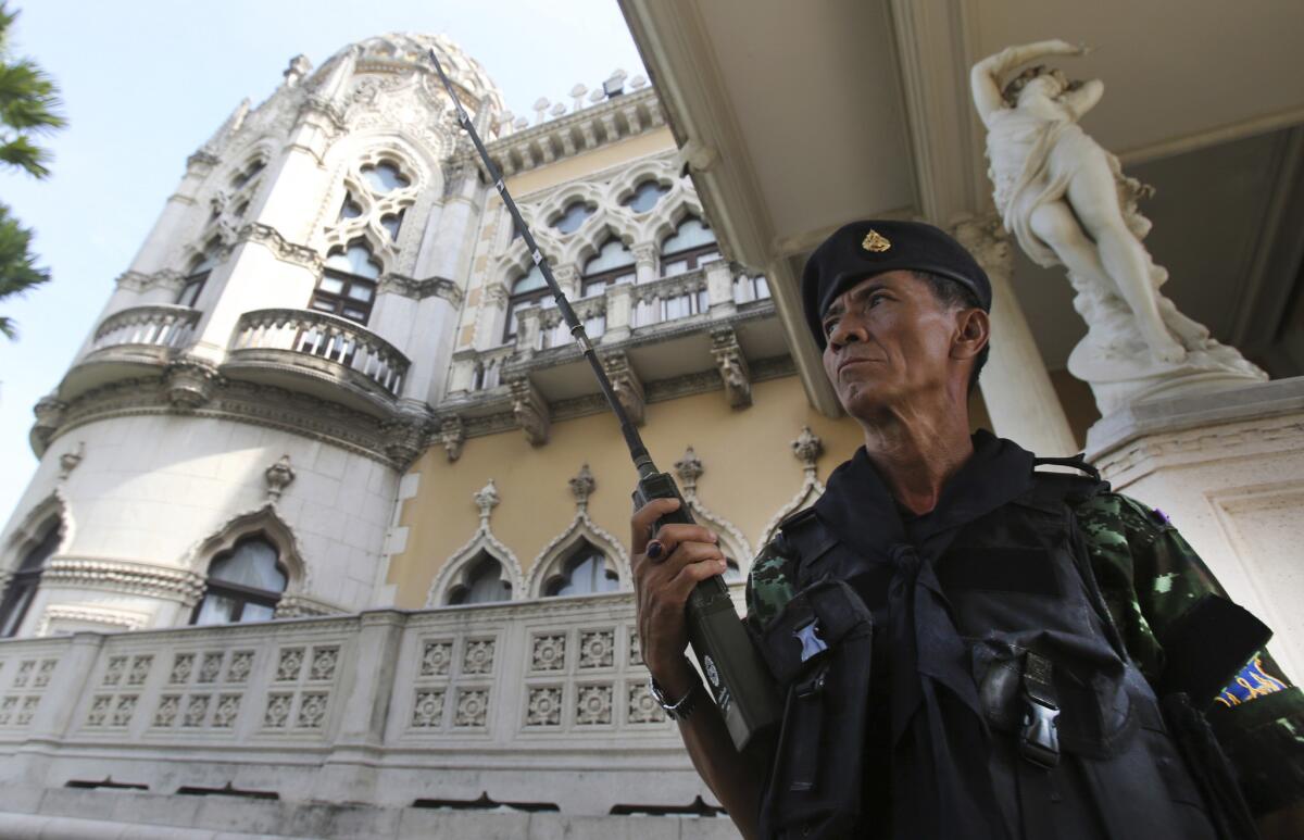 A soldier stands guard outside Government House in Bangkok, Thailand, after the army declared martial law.