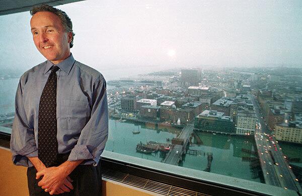 Land developer Frank McCourt stands in front of a window of his office in Boston in 2001. McCourt, president and chief executive of the McCourt Co., reached an agreement to purchase the Dodgers from Rupert Murdoch's News Corp., in October 2003.