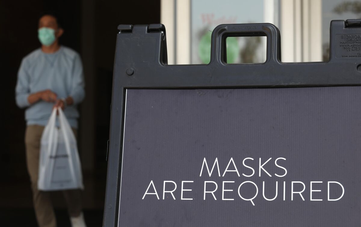 A sign at the Westfield Santa Anita shopping mall in Arcadia says masks are required.