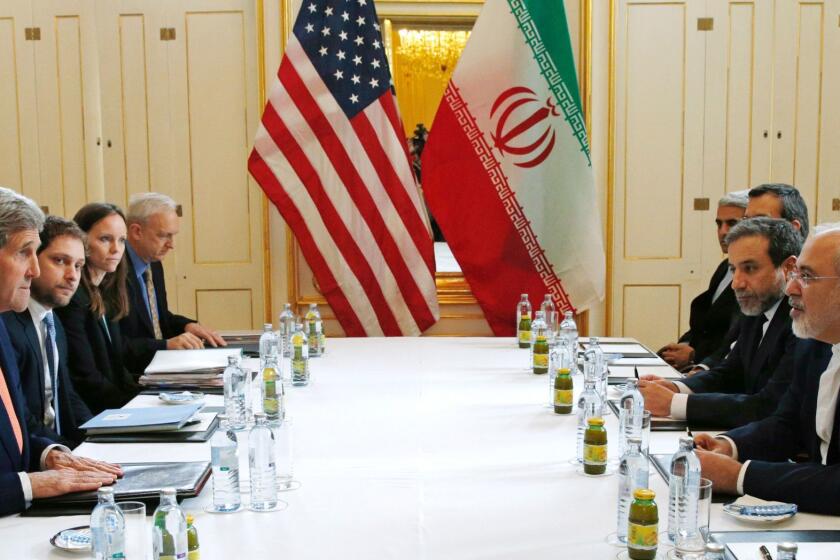 U.S. Secretary of State John F. Kerry, left, with Iranian Foreign Minister Mohammad Javad Zarif, right, in Vienna on Saturday.