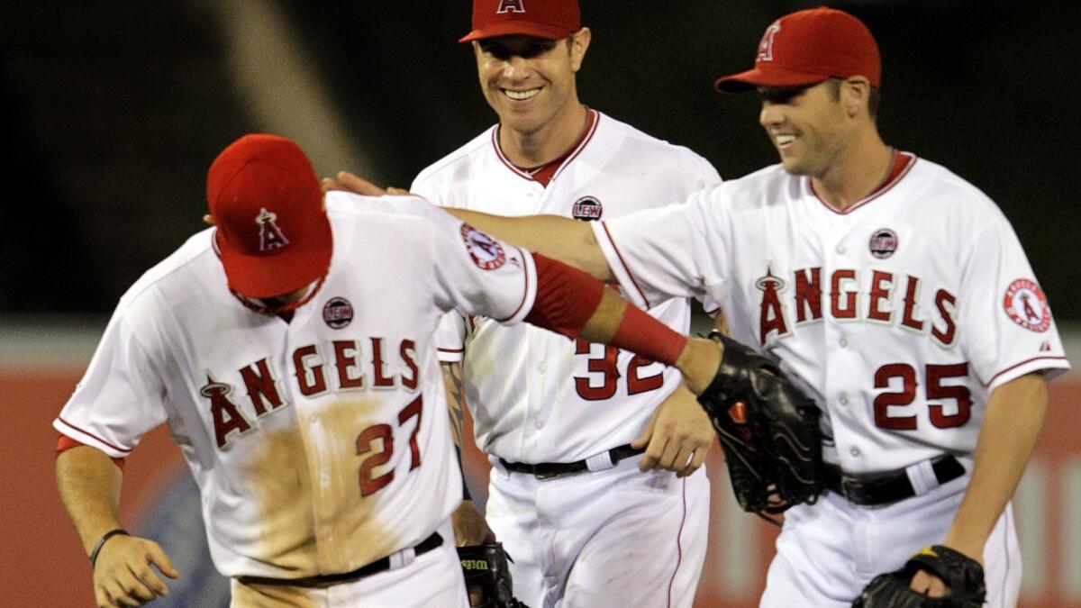 A 2013 photo shows Peter Bourjos patting Mike Trout on the back after a 10-9 comeback victory.