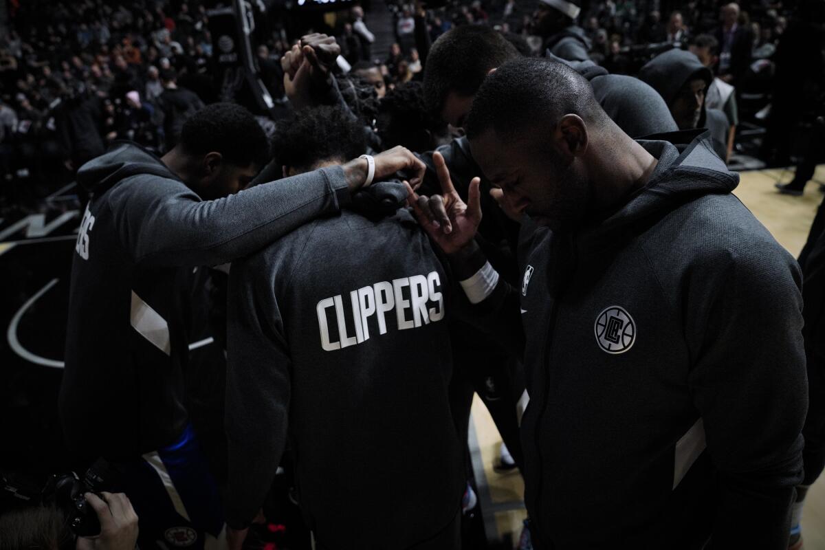 Clippers players huddle before the start of Friday's loss to the San Antonio Spurs.