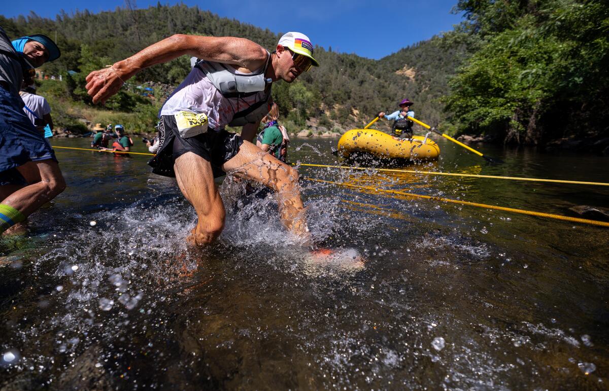 Runner Daniel Jones crosses the middle fork of the American River at Rucky Chucky