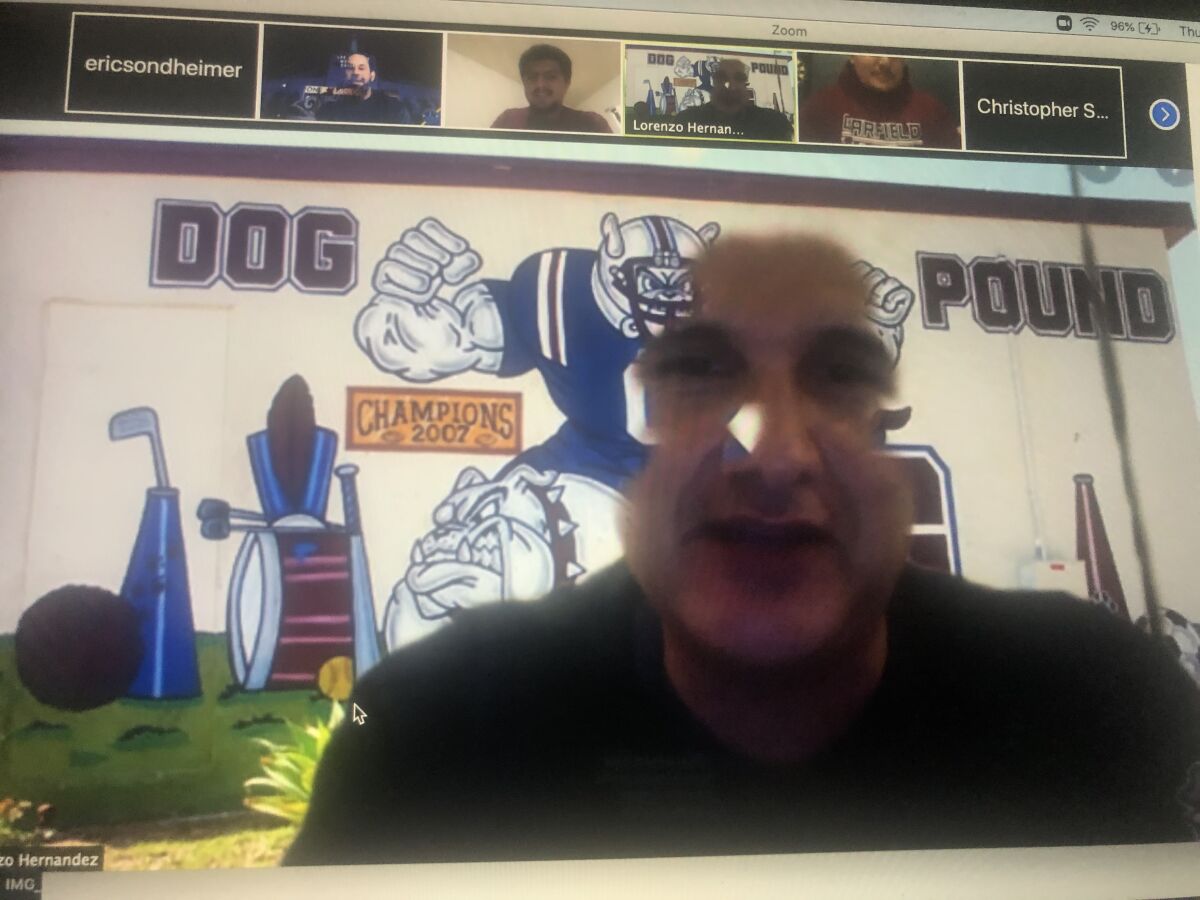 Garfield football coach Lorenzo Hernandez, using his virtual background, talks to his coaches on a Zoom video conference.