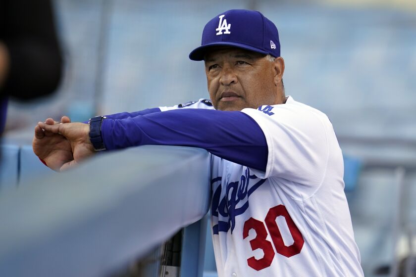 Los Angeles Dodgers manager Dave Roberts looks on in the dugout during a baseball game against the St. Louis Cardinals Wednesday, June 2, 2021, in Los Angeles. (AP Photo/Marcio Jose Sanchez)