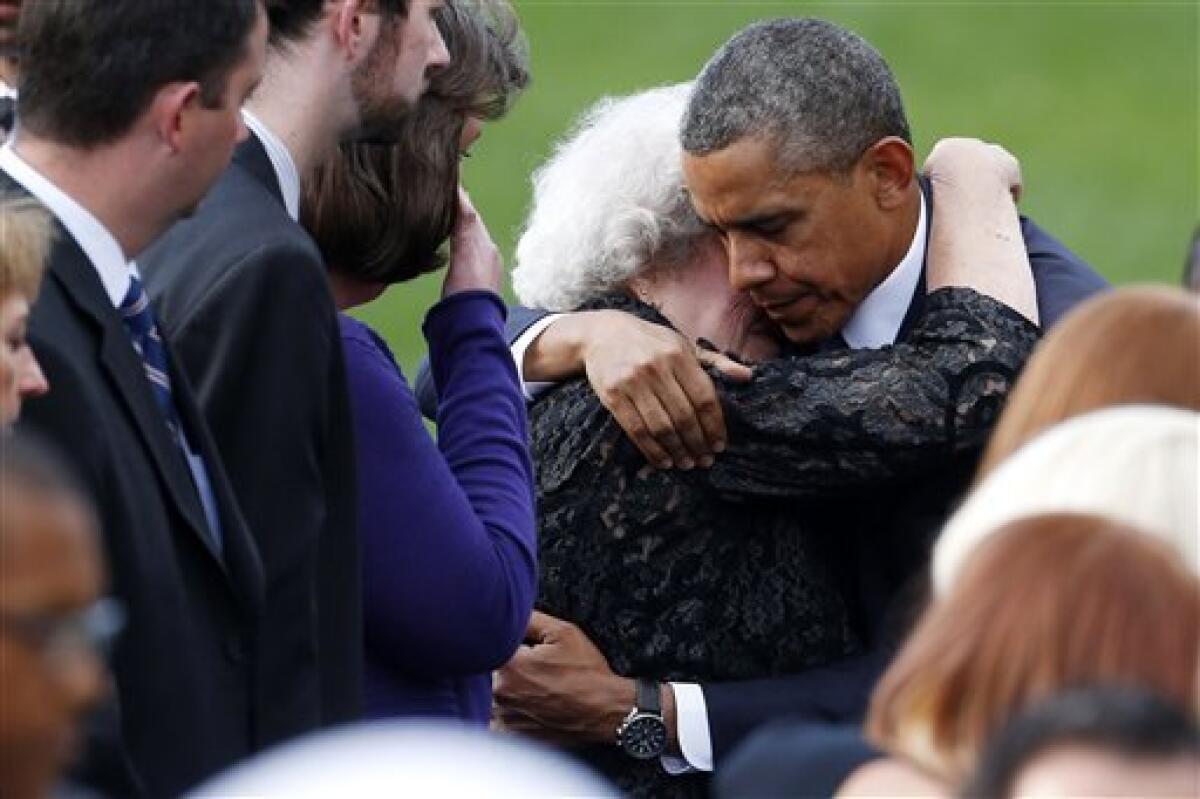 President Obama comforts a woman at a memorial service for the victims of the Washington Navy Yard shooting.