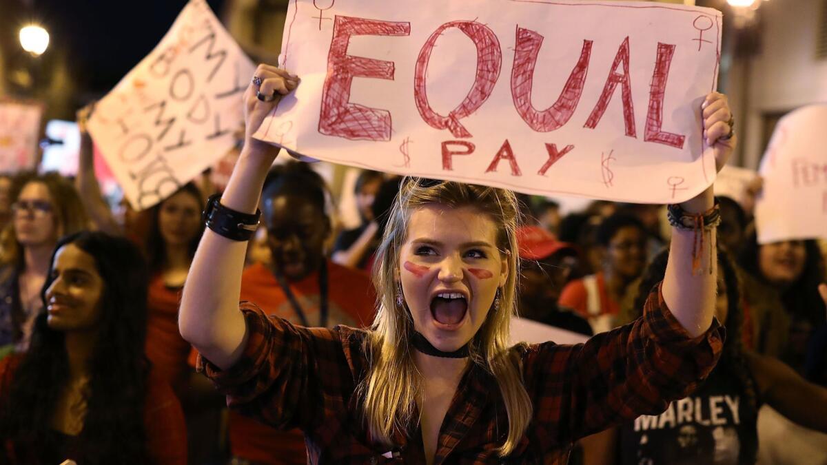 Clarissa Horsfall holds a sign at the "A Day Without A Woman" demonstration in Miami in March 2017.