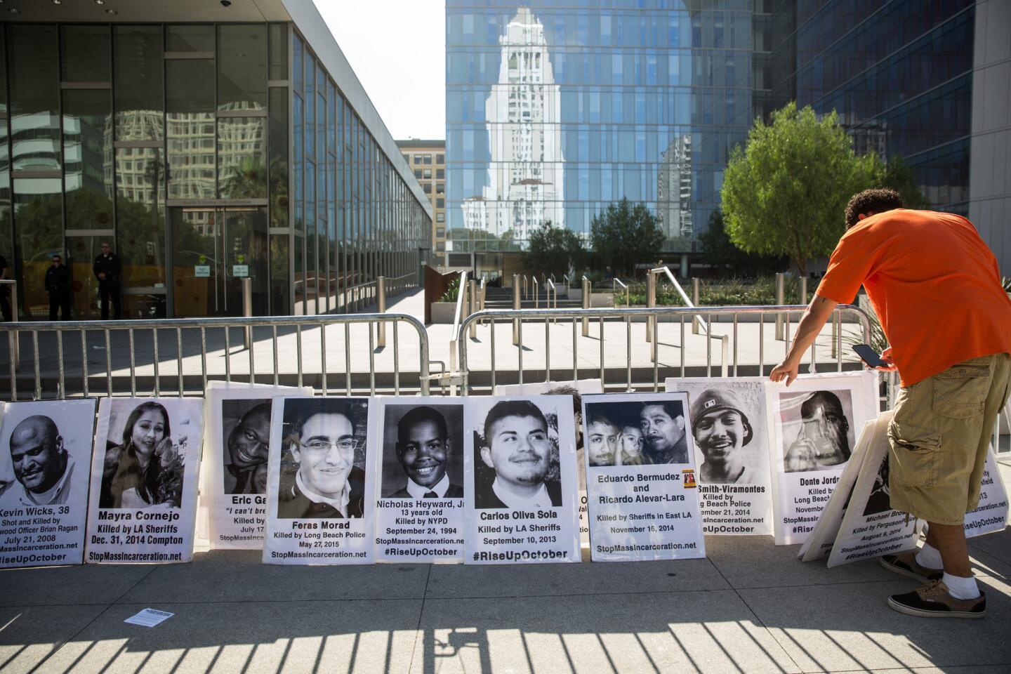 Protesters put up pictures of people killed by police at the National Day of Protest to Stop Police Brutality, Repression and the Criminalization of a Generation.