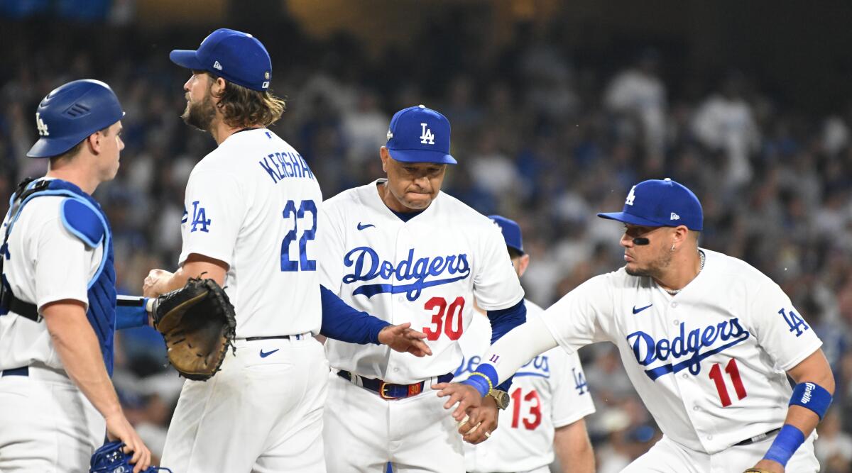 Dodgers manager Dave Roberts, center, removes Clayton Kershaw from the game against the Diamondbacks at Dodger Stadium.