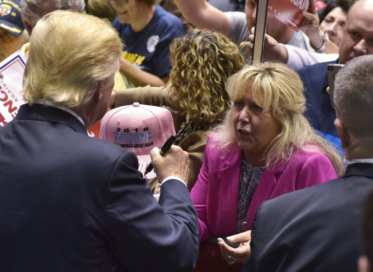 Republican presidential nominee Donald Trump signs autographs during a rally at the Canton Memorial Civic Center in Ohio.